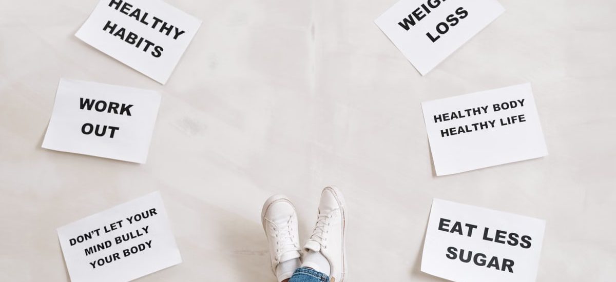 Inspirational health and fitness messages with shoe-clad feet, promoting healthy habits and wellbeing.